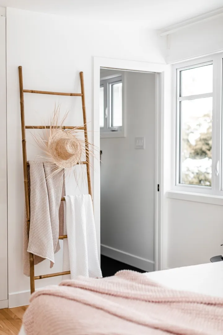 Vue large de la chambre principale — mur de tête de lit sur mesure avec éclairage intégré, bungalow de Montréal.
